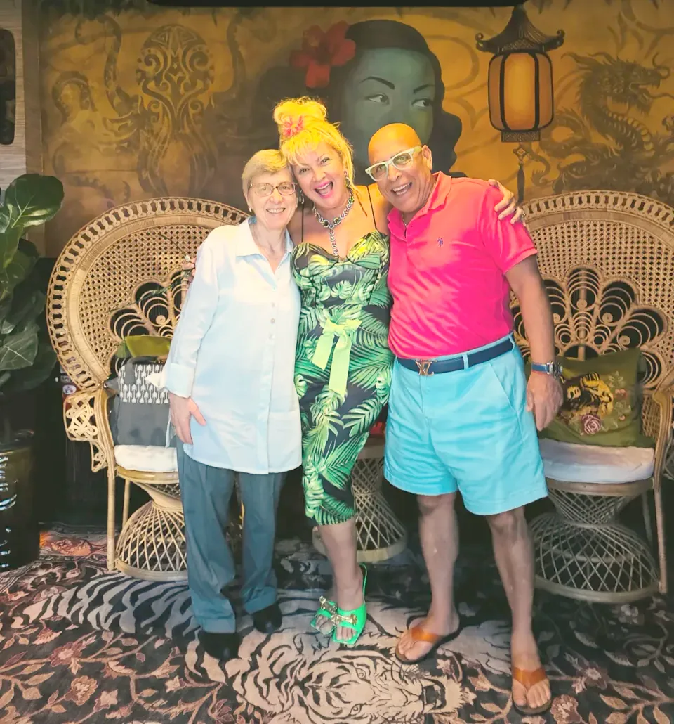 Frannie and Dani Sheridan-Michaeli with Dr. Gabriele Knaus, arm in arm and laughing in the center front room.