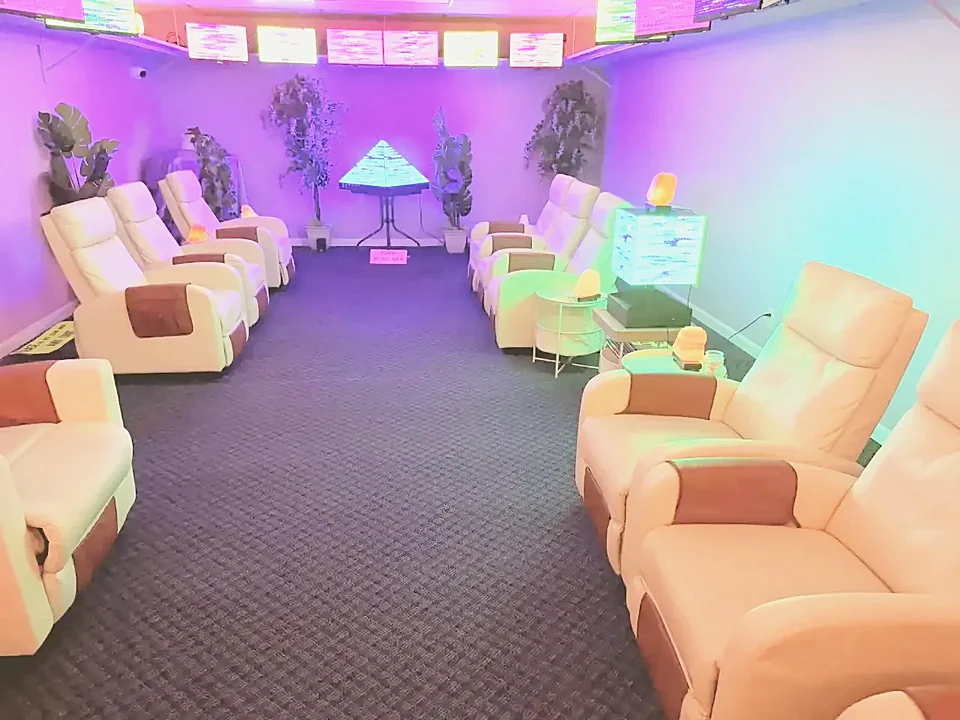 The same room from the opposite corner, showing the wall panels above and more recliners along both walls.